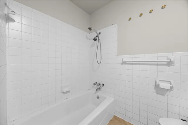 a bathroom with a shower and a bathtub