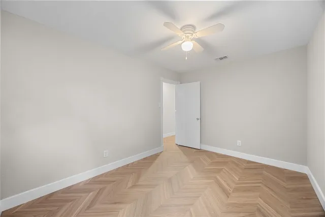 a view of a brick house with many windows next to a yard