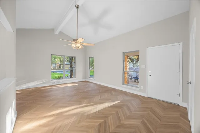 a view of a room with window and ceiling fan