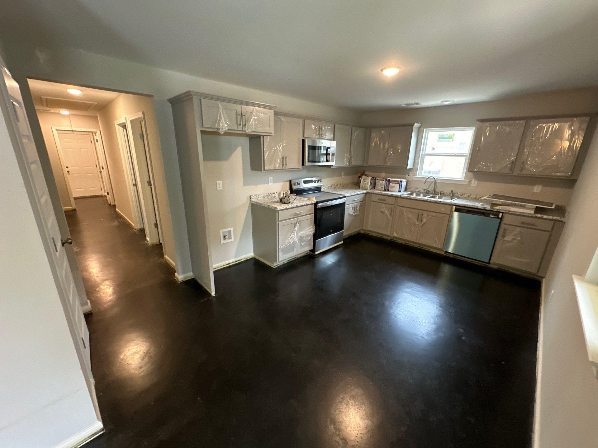 307 Harrell Street Memphis, TN 38112 - Photo 3 of 8 a kitchen with a refrigerator a sink dishwasher a stove and a dining table with wooden floor