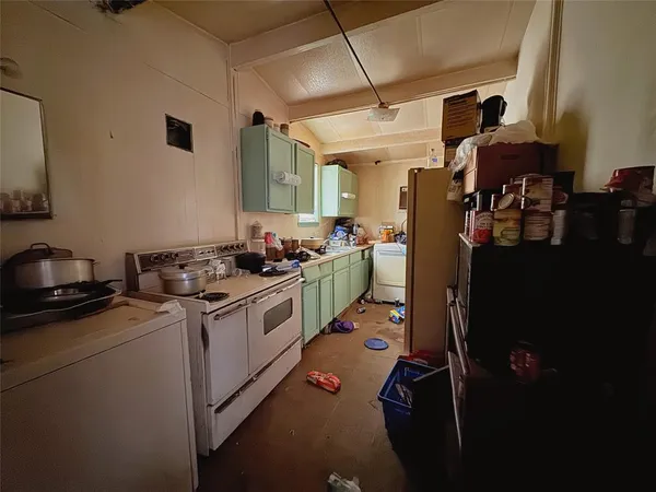 a kitchen with a sink stove and refrigerator