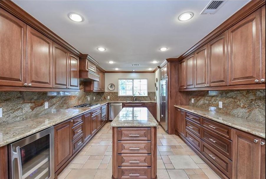 13123 Conifer Road Houston, TX 77079 - Photo 10 of 31 Kitchen has granite counters, stainless steel appliances and matching back splash. Updated Kitchen cabinets plenty of storage.