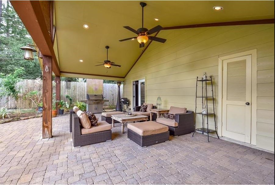13123 Conifer Road Houston, TX 77079 - Photo 24 of 31 Custom built covered Patio with two ceiling fans, Mosquito mister in the backyard. Door leads to outdoor half bathroom.