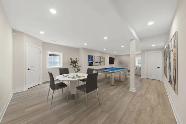 a dining room with furniture and wooden floor