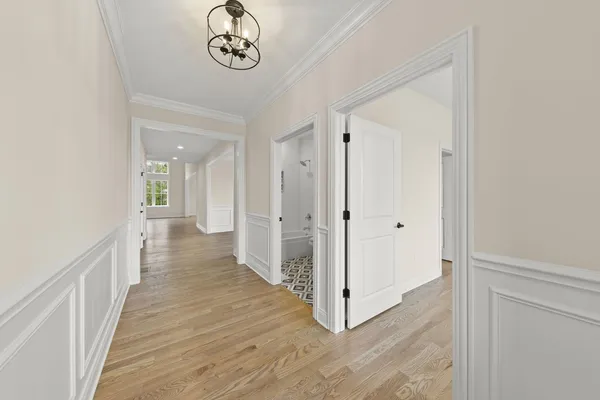 a view of a hallway with wooden floor