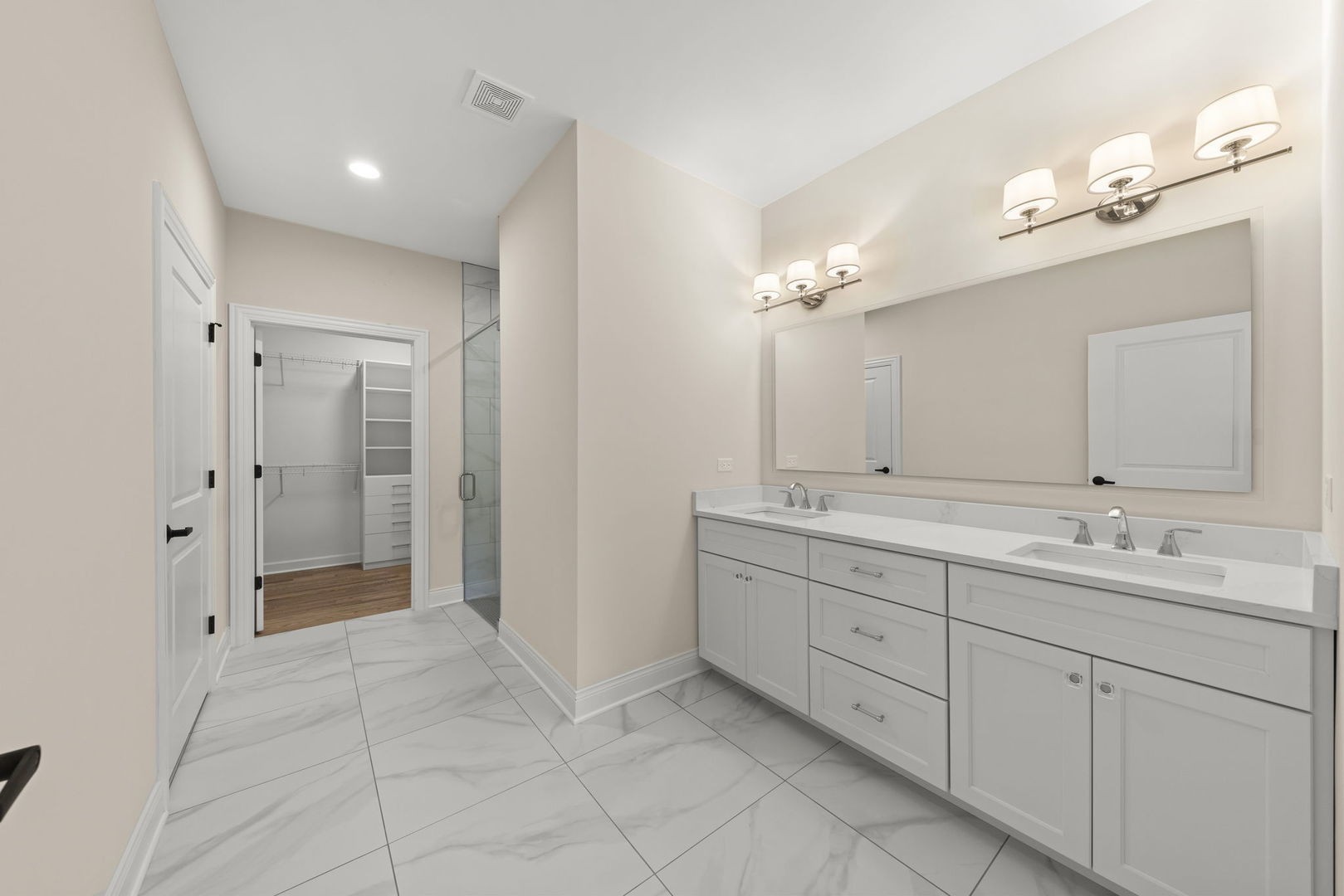 12185 Morandi Court Lemont, IL 60439 - Photo 7 of 13 a spacious bathroom with a double vanity sink a mirror and a shower