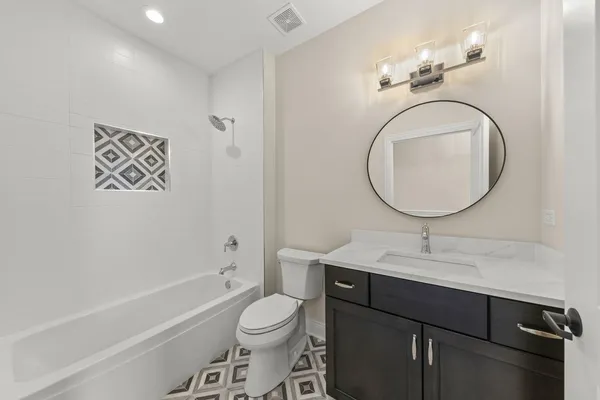 a bathroom with a toilet a sink and a mirror