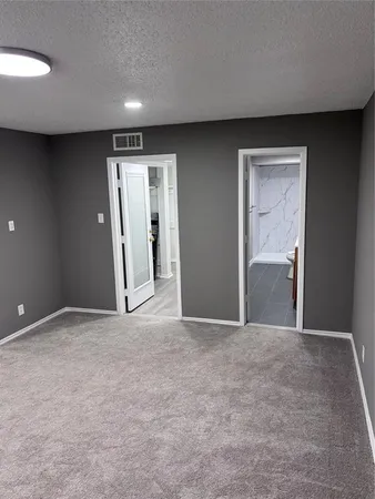a view of an empty room with a bathroom