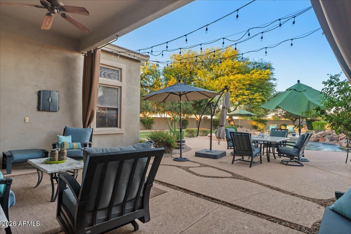 6427 South Magic Court Gilbert, AZ 85298 - Photo 45 of 71 a view of a patio with a table and chairs under an umbrella