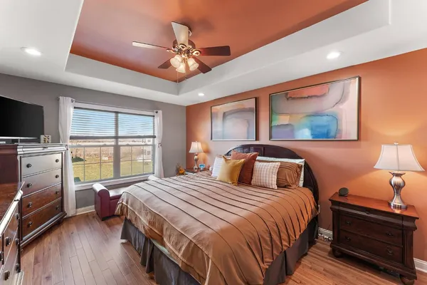 a bedroom with double bed windows and a flat screen tv