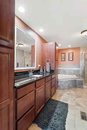 a large bathroom with a large mirror vanity and a sink