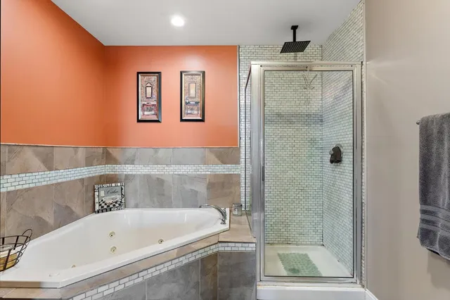 a bathroom with a bathtub and a shower