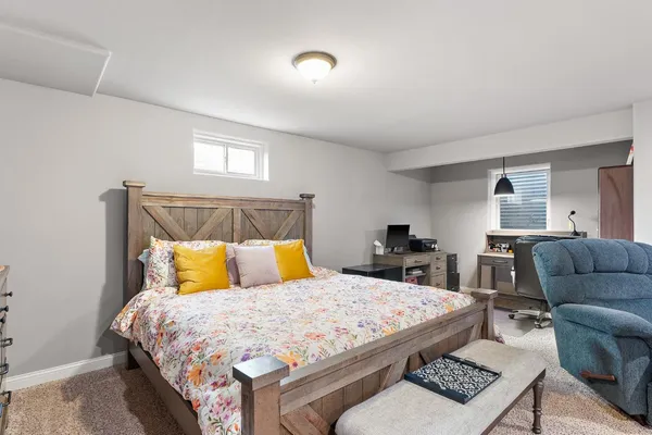 a bedroom with a bed a couch and dresser