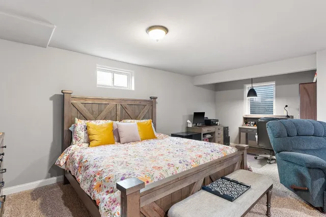 a bedroom with a bed a couch and dresser