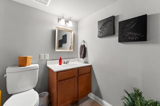 a room with a toilet workspace and a window