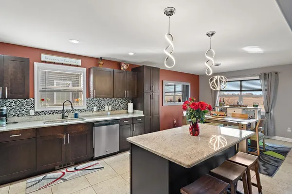 a kitchen with a stove a sink and a refrigerator