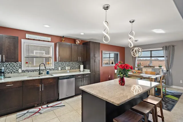 a kitchen with a stove a sink and a refrigerator