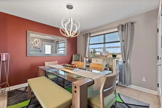 a view of a dining room with furniture a chandelier and wooden floor