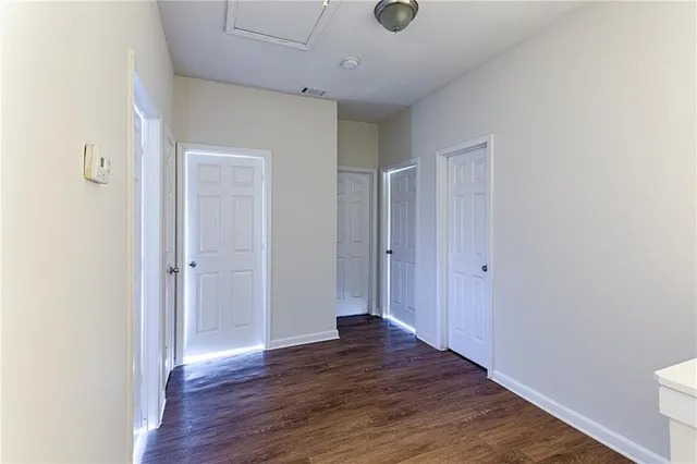an empty room with wooden floor and closet