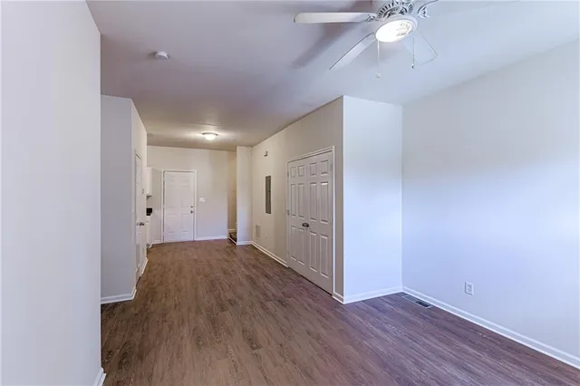 a view of an empty room with wooden floor