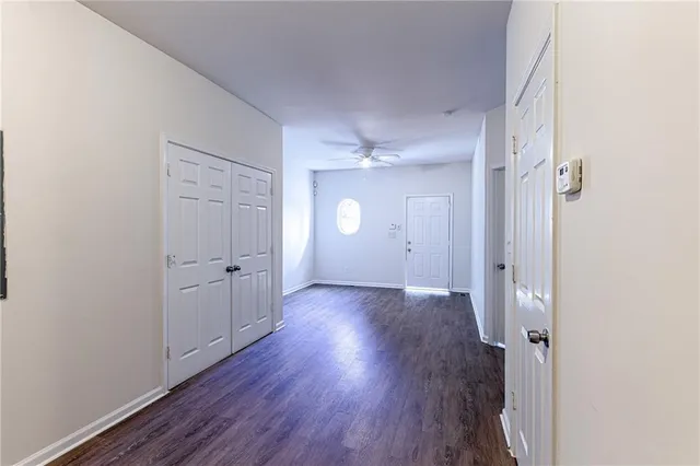 a view of a room with wooden floor