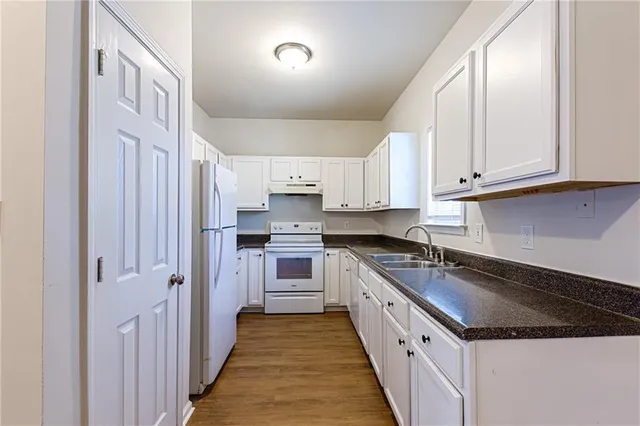 a kitchen with stainless steel appliances granite countertop a stove and a sink