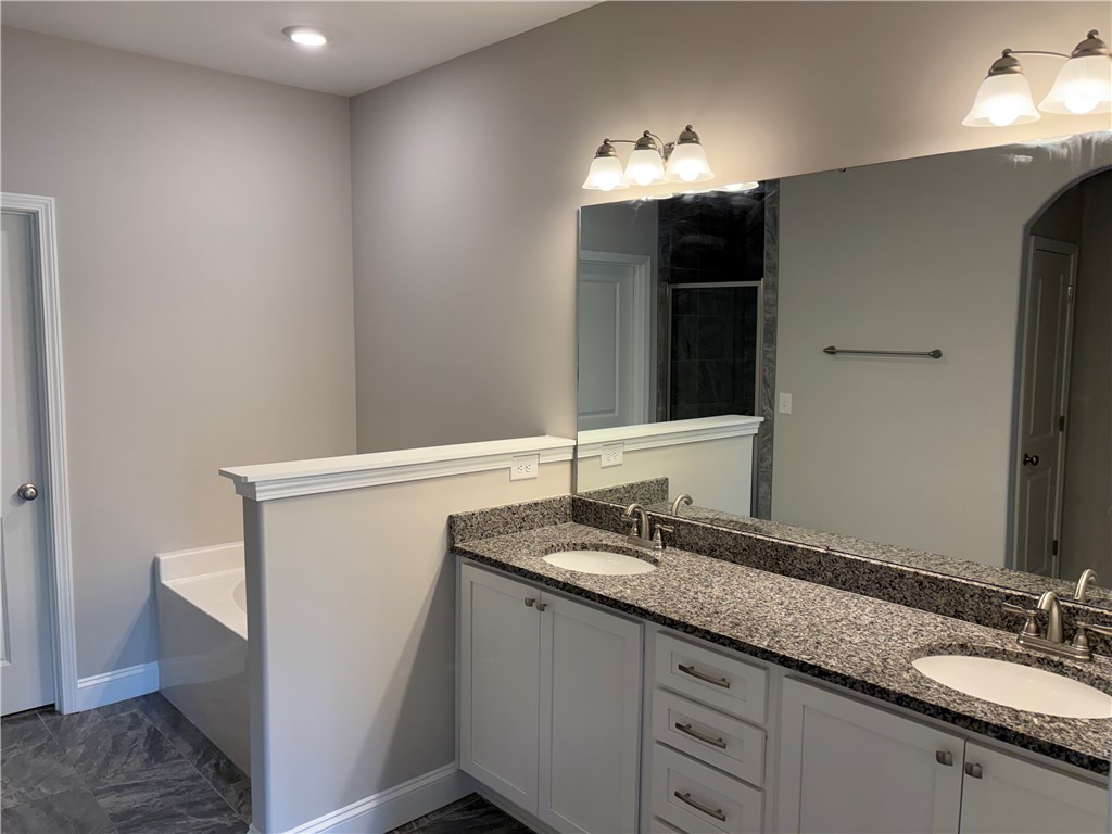 240 Meridian Way Seneca, SC 29672 - Photo 8 of 19 Indulge in a primary bathroom featuring a spacious dual vanity and elegant tile flooring.