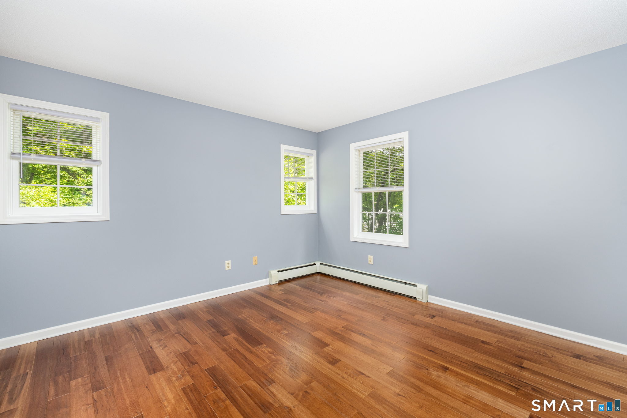 175 Vernon Street Manchester, CT 06042 - Photo 14 of 38 an empty room with wooden floor and windows