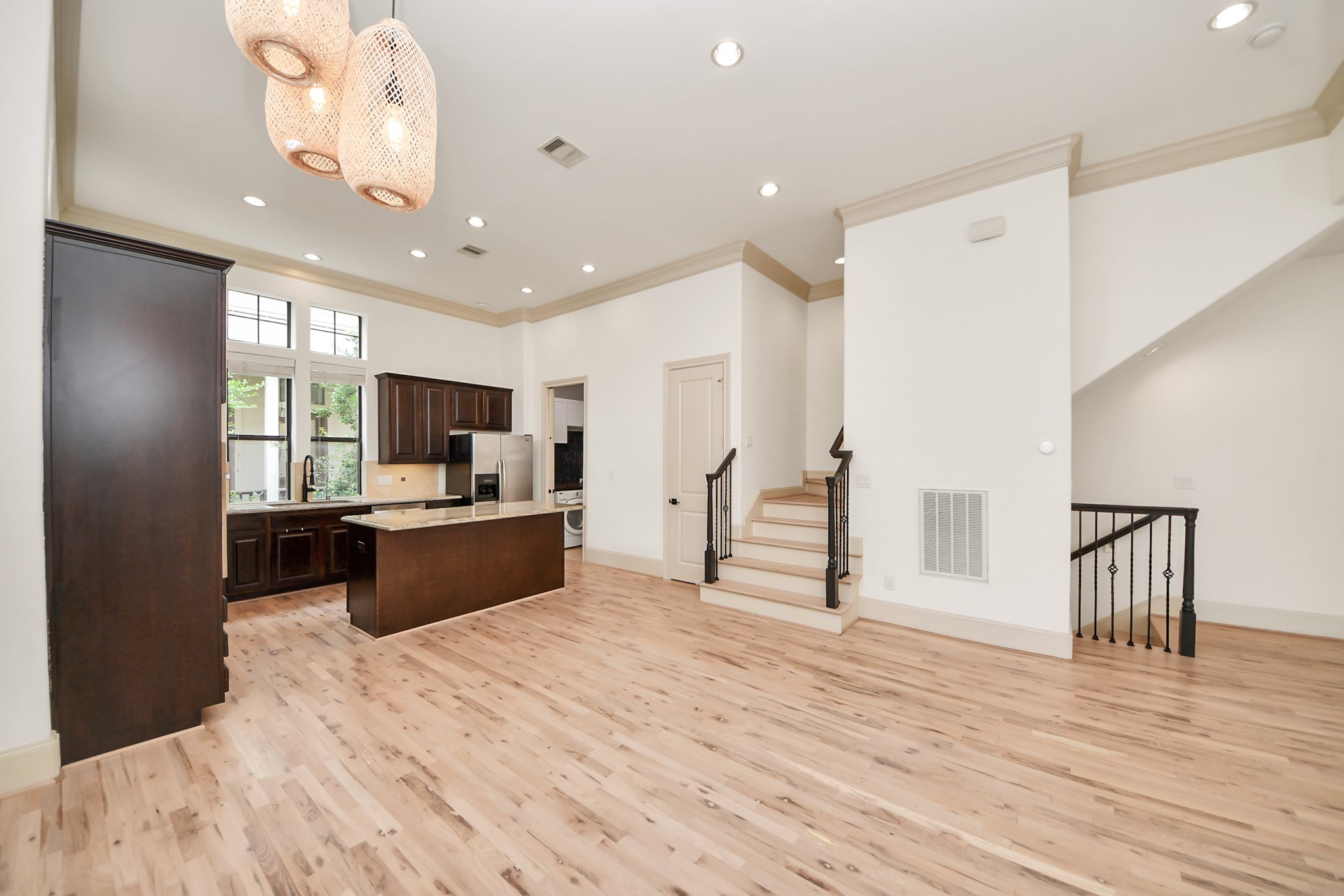 3229 Maxroy Street Houston, TX 77008 - Photo 19 of 43 A spacious dining area that flows seamlessly into the kitchen, featuring high ceilings, wood floors, and a stylish pendant light fixture.