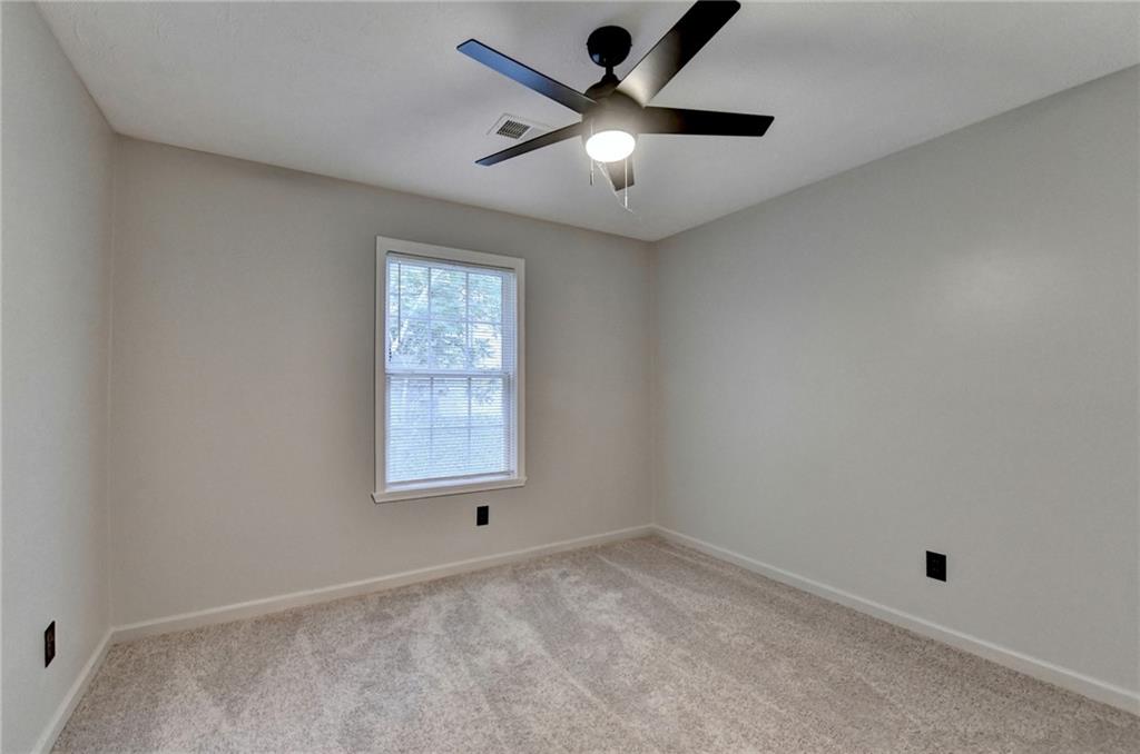 801 Davis Street Monroe, GA 30655 - Photo 16 of 33 an empty room with a window and a fan