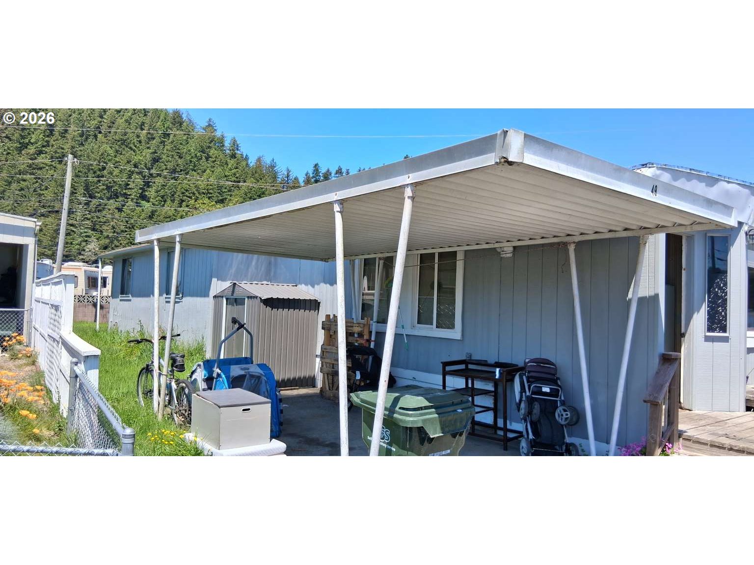 1413 Hawthorne Avenue, Unit 49 Reedsport, OR 97467 - Photo 7 of 10 a view of a backyard with table and chairs