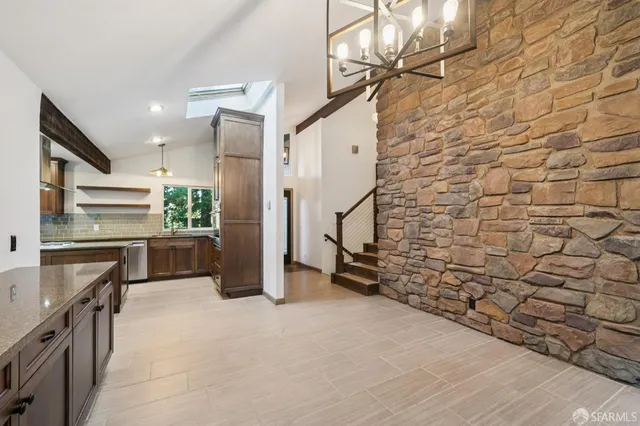 a kitchen with windows and refrigerator