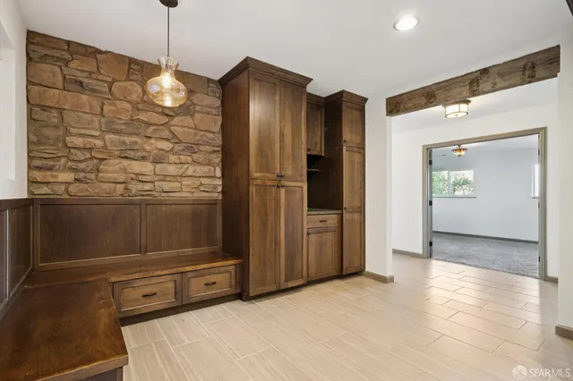 a view of backyard with wooden fence and large trees