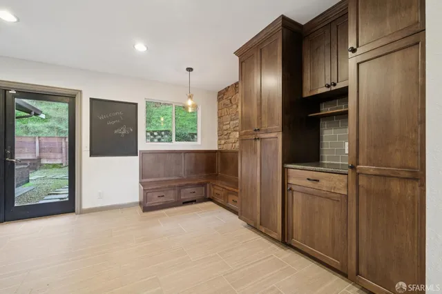 a view of a house with backyard and sitting area