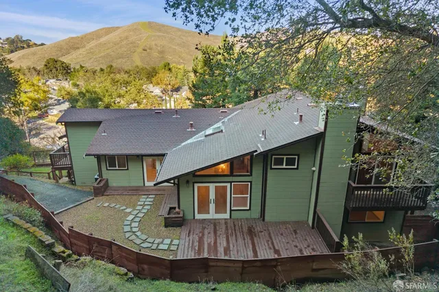 a view of a house with a mountain and a forest