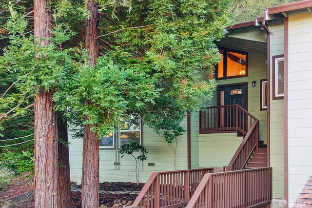 a kitchen with stainless steel appliances granite countertop a sink a stove and a refrigerator