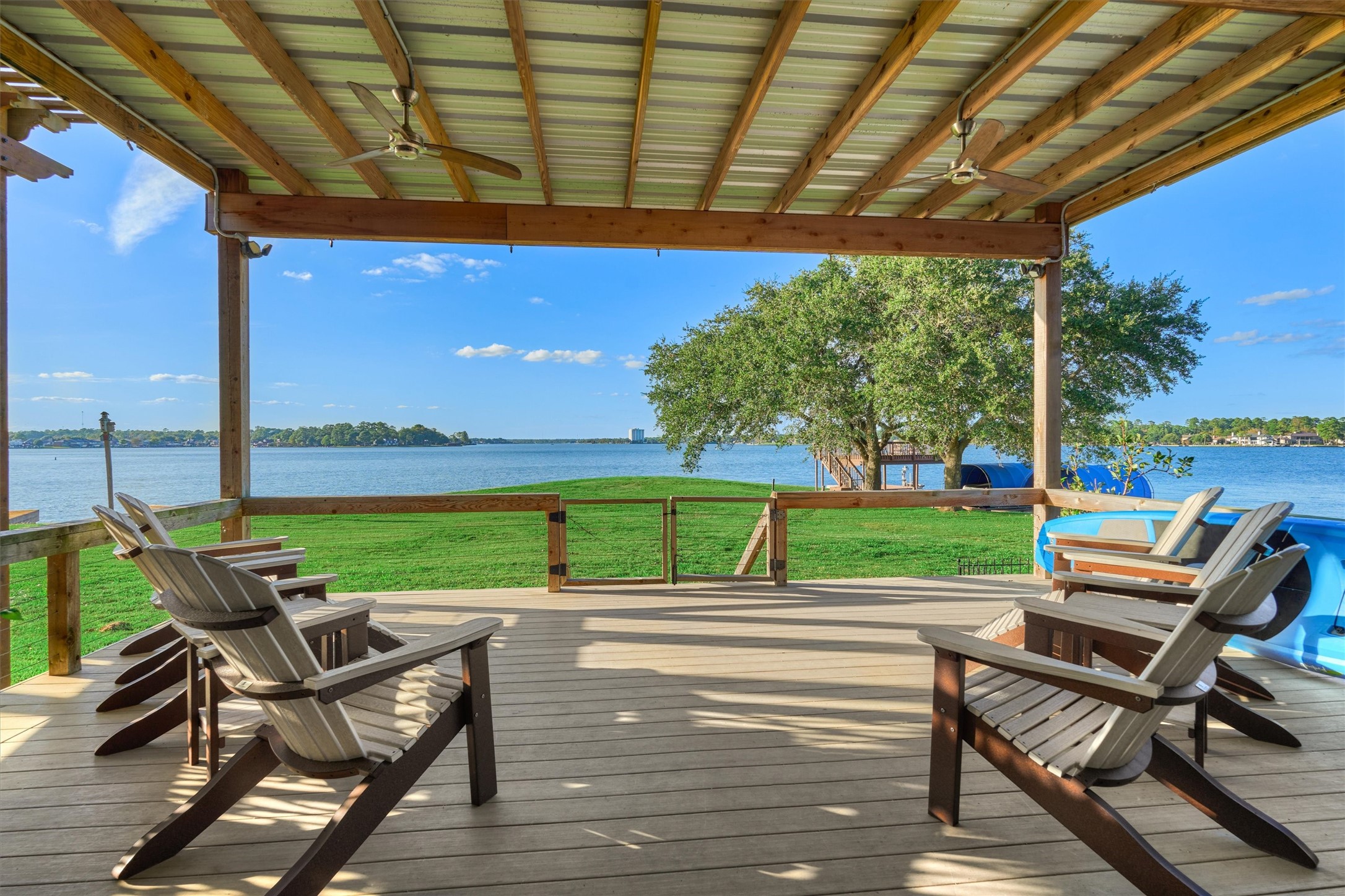 a view of a patio with chairs and table under an umbrella