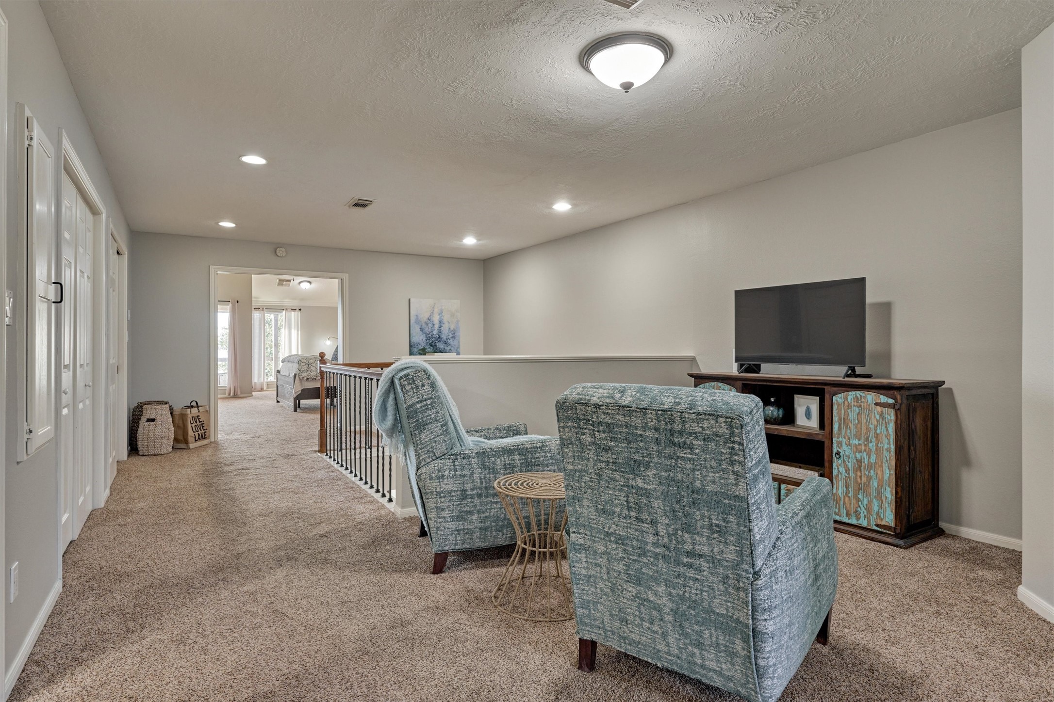 157 Capetown Way Conroe, TX 77356 - Photo 14 of 32 a living room with furniture and a flat screen tv