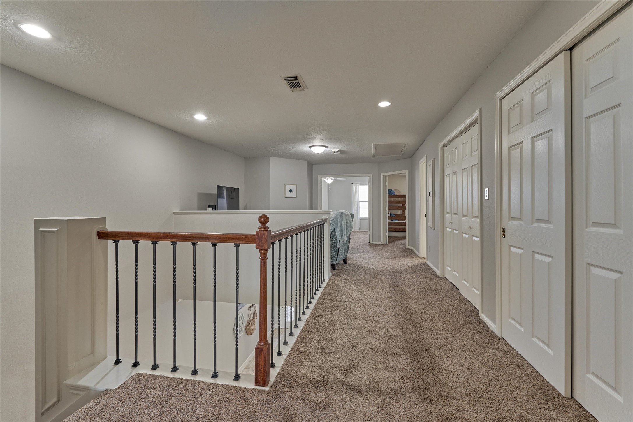 157 Capetown Way Conroe, TX 77356 - Photo 15 of 32 a view of a hallway with a dining room and stairs