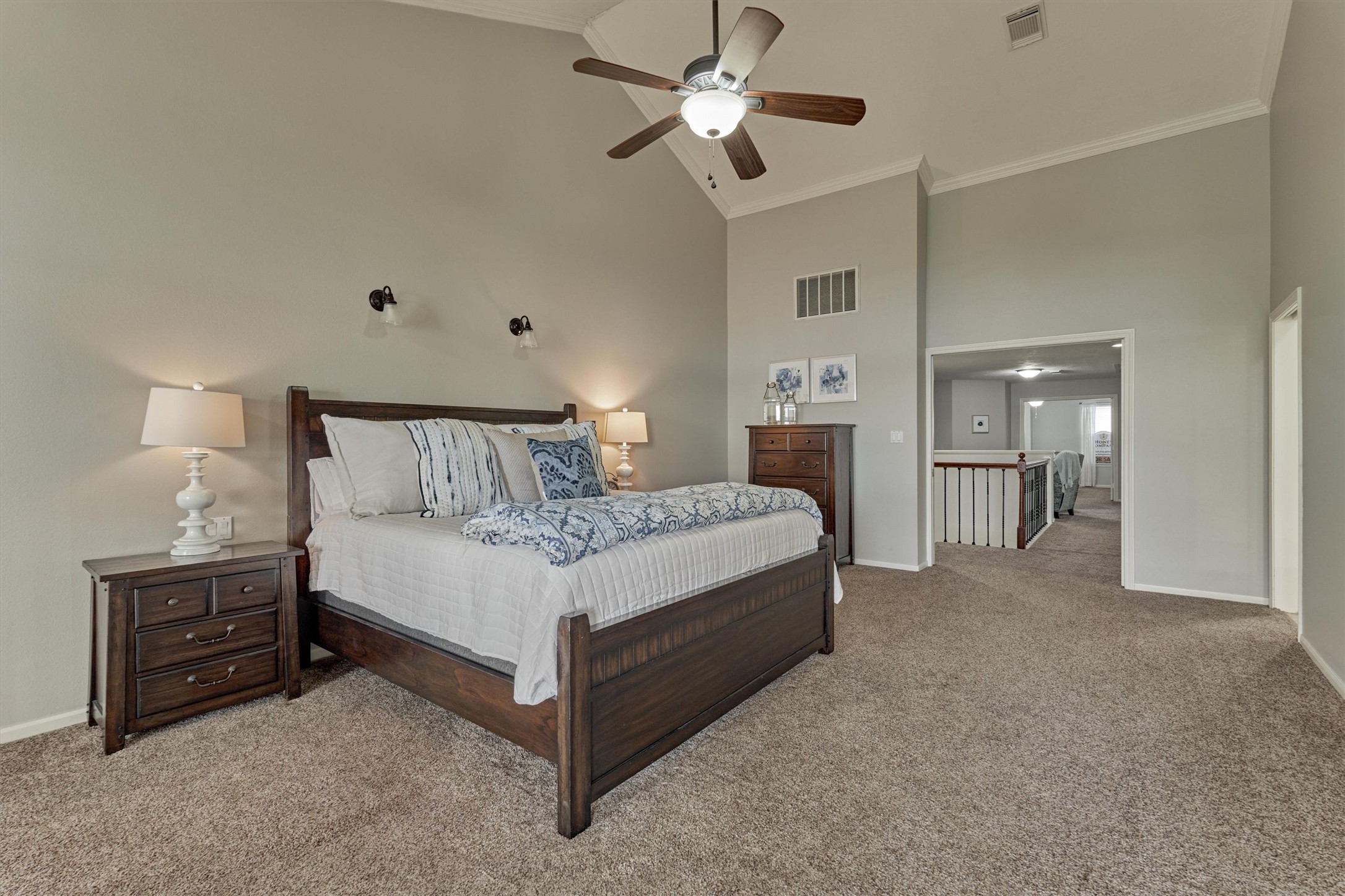 157 Capetown Way Conroe, TX 77356 - Photo 18 of 32 a bedroom with a bed and a chandelier