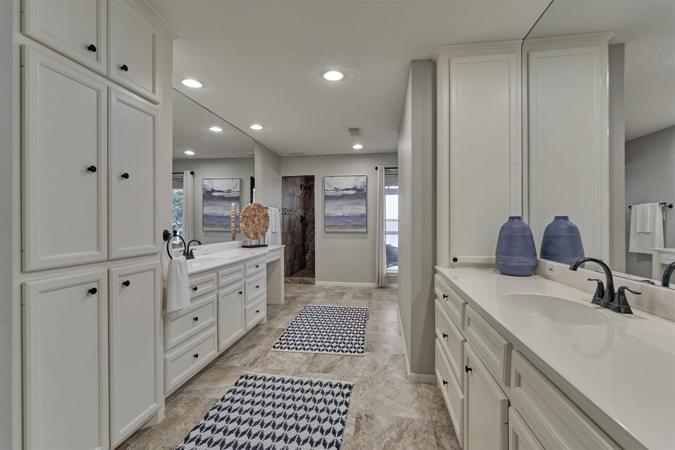 157 Capetown Way Conroe, TX 77356 - Photo 21 of 32 a large bathroom with a double vanity sink a mirror and a shower