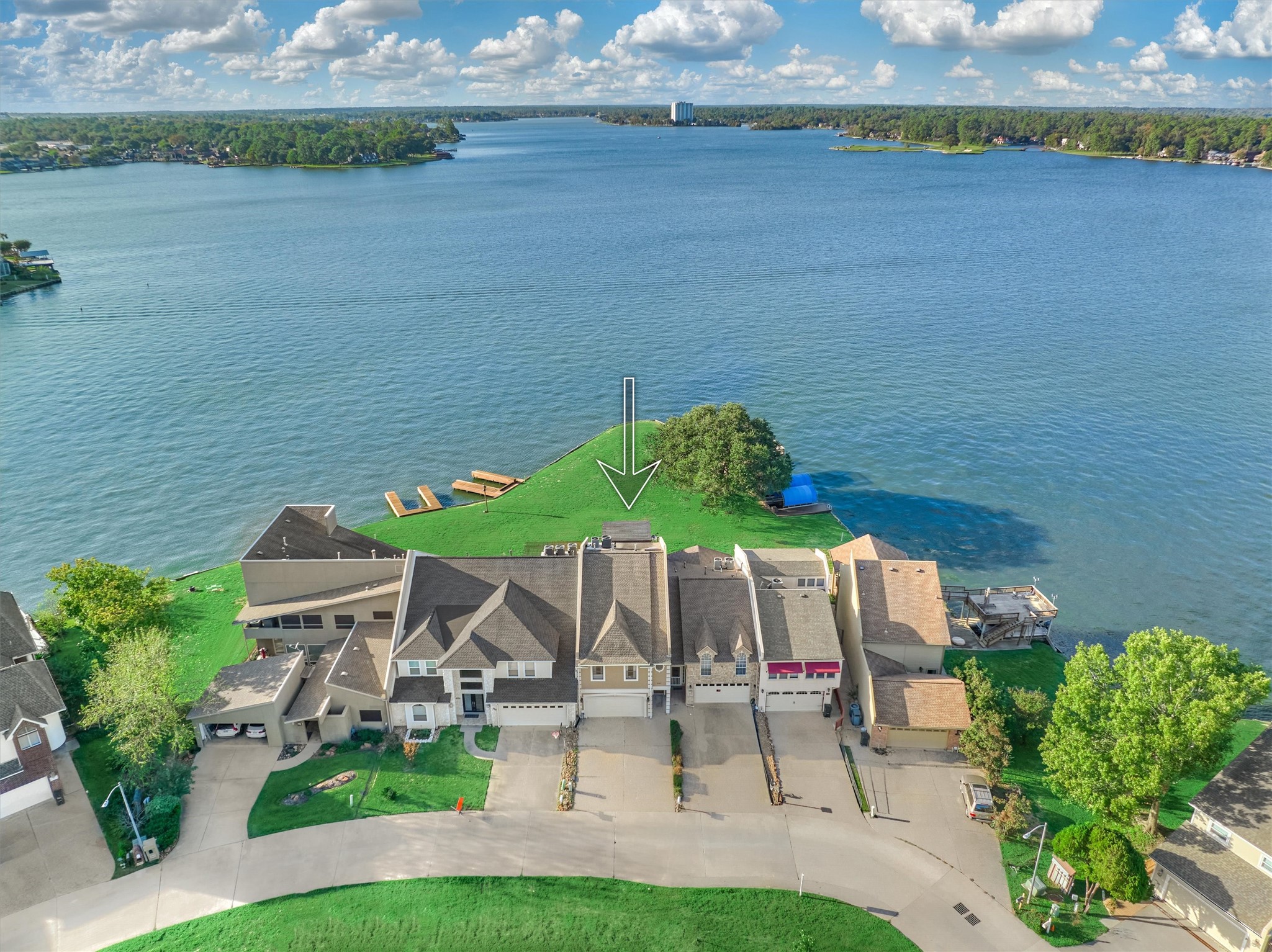 157 Capetown Way Conroe, TX 77356 - Photo 3 of 32 a view of a table and chairs in patio with a lake view
