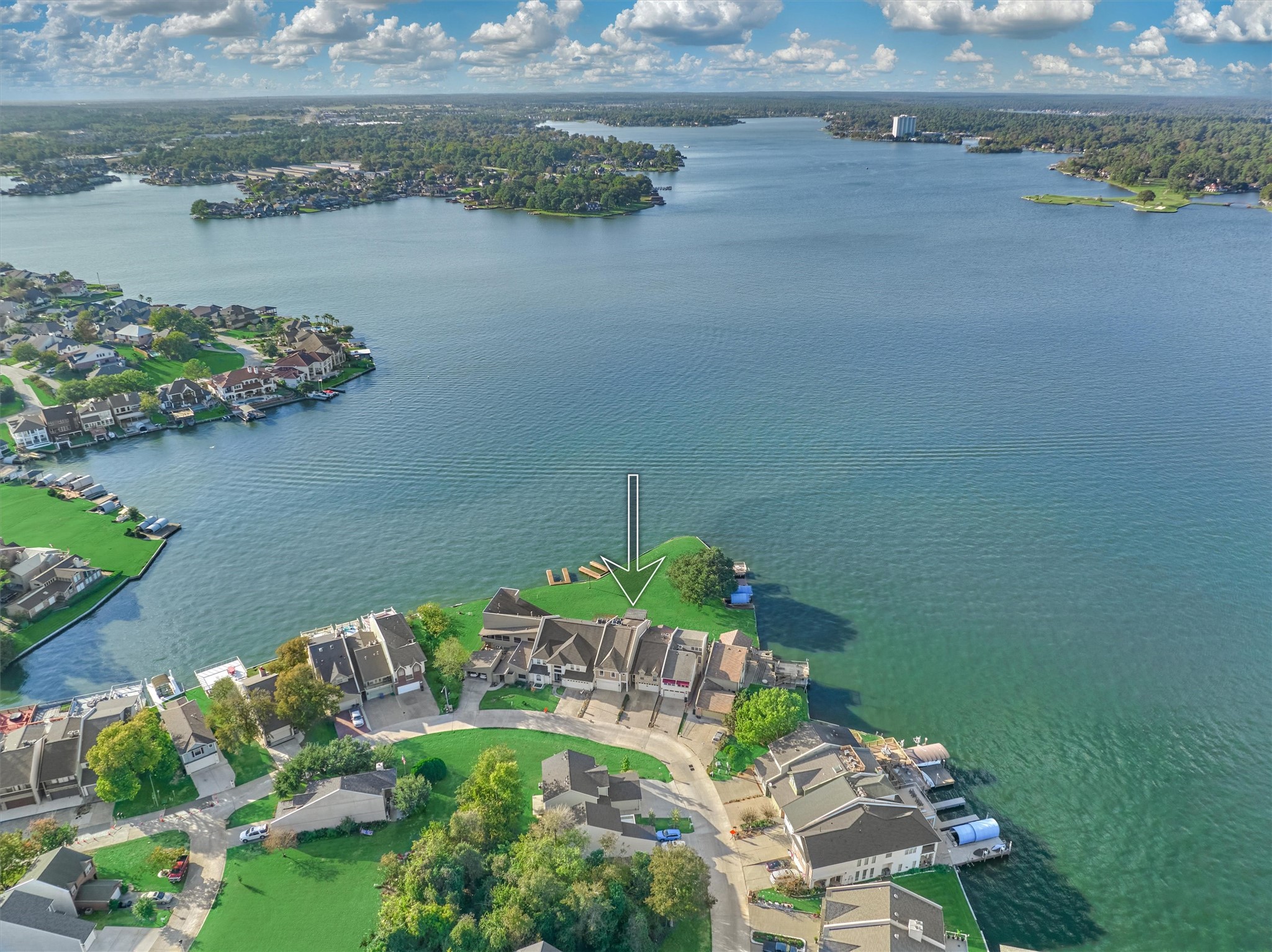 157 Capetown Way Conroe, TX 77356 - Photo 32 of 32 a view of a lake with lawn chairs