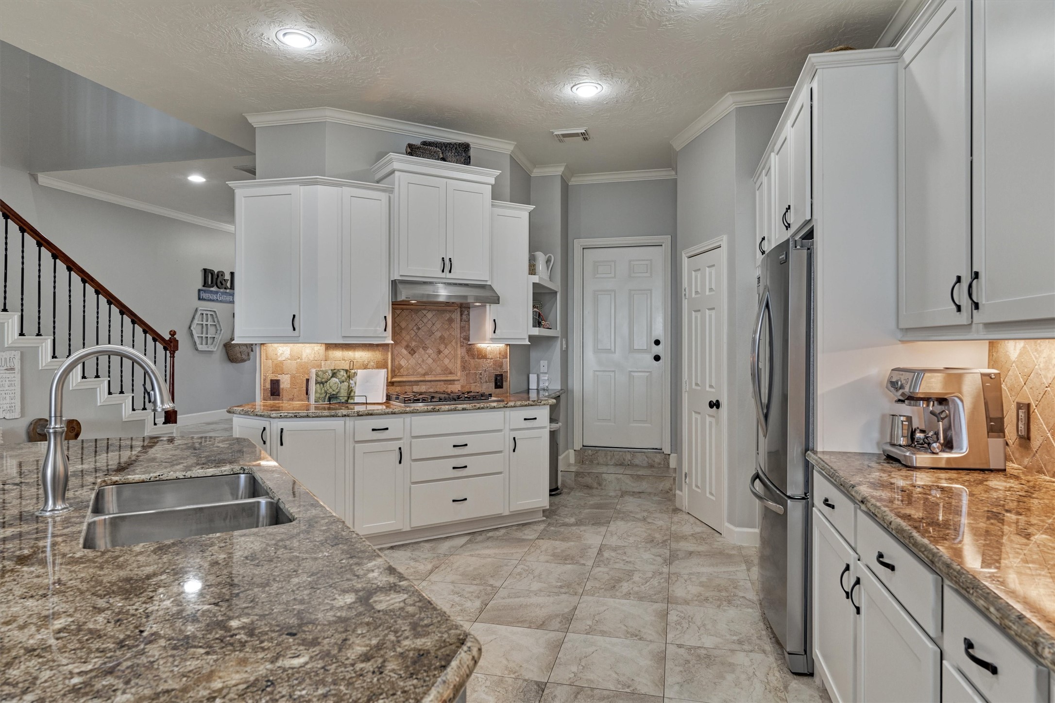 157 Capetown Way Conroe, TX 77356 - Photo 9 of 32 a room with kitchen island cabinets and stainless steel appliances