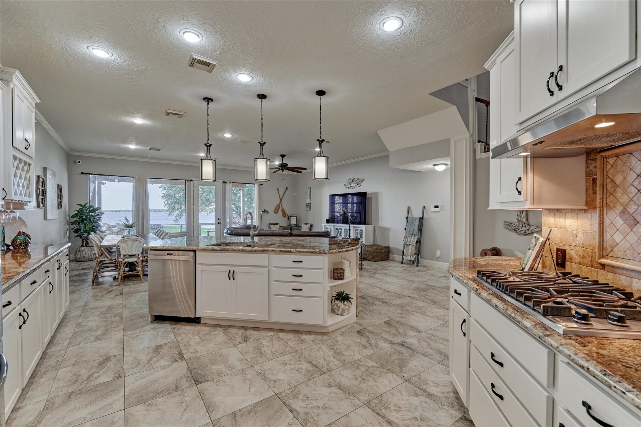 157 Capetown Way Conroe, TX 77356 - Photo 10 of 32 a large kitchen with kitchen island a large counter space a sink appliances and cabinets