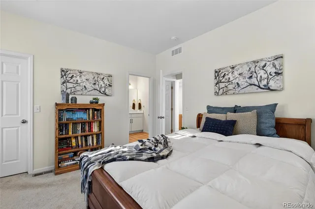 a bedroom with a bed and a bookshelf