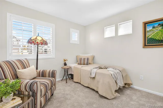 a bedroom with bed and a large window