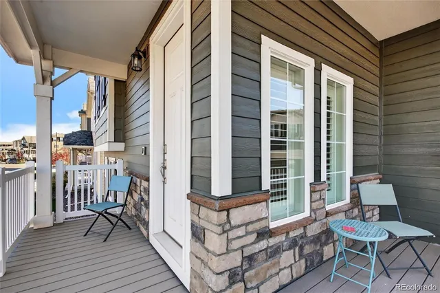 a balcony view with a couple of chairs and a barbeque