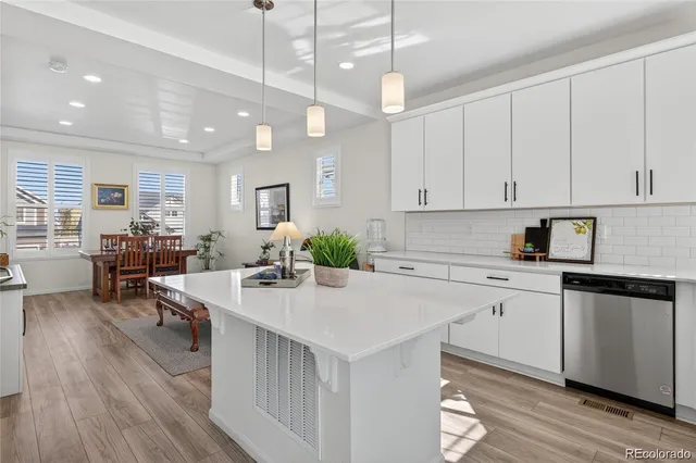 a kitchen with counter top space a sink appliances and cabinets