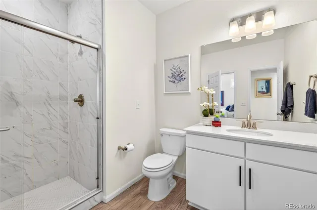 a bathroom with a toilet a sink and a mirror